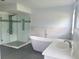 This modern bathroom features a soaking tub, glass shower, and updated vanity at 283 Pine Arbor Dr, Orlando, FL 32825