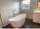 Bright bathroom featuring a soaking tub and window at 283 Pine Arbor Dr, Orlando, FL 32825