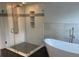 Elegant bathroom featuring a walk-in shower and a soaking tub at 283 Pine Arbor Dr, Orlando, FL 32825