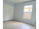 Bright bedroom features neutral paint and flooring with a large window at 283 Pine Arbor Dr, Orlando, FL 32825