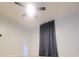 Bright bedroom with neutral walls, ceiling fan, and a blackout curtain at 283 Pine Arbor Dr, Orlando, FL 32825