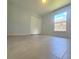 Bright bedroom features neutral paint and flooring with a view from the window at 283 Pine Arbor Dr, Orlando, FL 32825