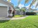 Well-maintained home featuring lush landscaping and a freshly mowed lawn at 283 Pine Arbor Dr, Orlando, FL 32825