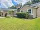 Charming single-story home with a well-maintained lawn and tropical landscaping at 283 Pine Arbor Dr, Orlando, FL 32825
