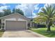 Attached two-car garage with a neutral color scheme and driveway at 283 Pine Arbor Dr, Orlando, FL 32825