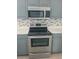 Modern kitchen showcasing stainless steel appliances, tile backsplash, and ample counter space at 283 Pine Arbor Dr, Orlando, FL 32825