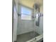 Large shower features a glass enclosure, modern fixtures, and patterned tiles at 283 Pine Arbor Dr, Orlando, FL 32825