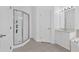 All-white bathroom with glass-enclosed shower and single sink vanity at 2855 Club Cortile Cir, Kissimmee, FL 34746