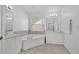 Bathroom featuring a corner soaking tub, double sink vanity, and tile flooring at 2855 Club Cortile Cir, Kissimmee, FL 34746