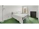 Bright bedroom with a bed, dresser, window, and plush green carpeting at 2855 Club Cortile Cir, Kissimmee, FL 34746
