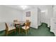 Dining area with a simple table, wooden chairs, and white wall at 2855 Club Cortile Cir, Kissimmee, FL 34746