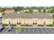 Exterior shot of the townhome featuring manicured landscaping and convenient parking spaces at 2855 Club Cortile Cir, Kissimmee, FL 34746