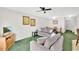 Cozy living room with comfortable seating, green carpet, and ample light at 2855 Club Cortile Cir, Kissimmee, FL 34746