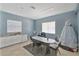 Bright meeting room with tile flooring, large windows, and a kitchenette at 2855 Club Cortile Cir, Kissimmee, FL 34746