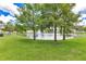 A serene pond surrounded by lush greenery, offering a tranquil view at 2855 Club Cortile Cir, Kissimmee, FL 34746