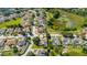 Overhead view of a residential area featuring well-maintained homes and a picturesque natural pond at 305 Grand Reserve Dr, Davenport, FL 33837
