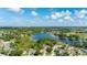 Stunning aerial shot of a home in a beautiful community, surrounded by green spaces and a tranquil lake at 305 Grand Reserve Dr, Davenport, FL 33837