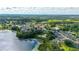 Scenic aerial view of a home nestled in a community near a lake surrounded by nature at 305 Grand Reserve Dr, Davenport, FL 33837