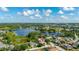 Scenic aerial view showcasing a home in a lush, green community with a serene lake backdrop at 305 Grand Reserve Dr, Davenport, FL 33837