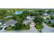 An inviting home featuring lush landscaping, mature trees, and serene lake views at 305 Grand Reserve Dr, Davenport, FL 33837