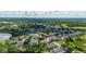 Overhead view showcases a community near a lake with lush foliage and beautiful scenery at 305 Grand Reserve Dr, Davenport, FL 33837