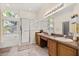 Bright primary bathroom with double sinks, vanity, and separate shower and soaking tub under large windows at 305 Grand Reserve Dr, Davenport, FL 33837