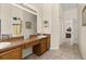 Bright bathroom with tile flooring, double sinks, and a large mirror with vanity lighting at 305 Grand Reserve Dr, Davenport, FL 33837