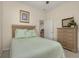 Tranquil bedroom featuring neutral colors, a wooden dresser, and comfortable bed at 305 Grand Reserve Dr, Davenport, FL 33837
