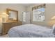 Bedroom with neutral tones, closet, large bed, mirror, and dresser at 305 Grand Reserve Dr, Davenport, FL 33837