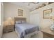 Bedroom with neutral tones, carpet, and large bed; bedside table and closet at 305 Grand Reserve Dr, Davenport, FL 33837