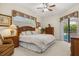 Relaxing bedroom with natural light, king bed, carpet flooring and direct access to the pool at 305 Grand Reserve Dr, Davenport, FL 33837