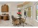 Bright breakfast nook features tile flooring and a glass table with seating for four at 305 Grand Reserve Dr, Davenport, FL 33837