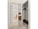 View from walk-in closet into the main bedroom and bathroom, with mirrored doors and neutral color scheme at 305 Grand Reserve Dr, Davenport, FL 33837