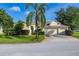 Charming single-story home with a well-manicured lawn, mature landscaping, and an attached two-car garage at 305 Grand Reserve Dr, Davenport, FL 33837