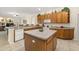 Spacious kitchen with tile flooring, a center island, and lots of wooden cabinets for ample storage at 305 Grand Reserve Dr, Davenport, FL 33837