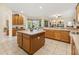 Kitchen with center island, tiled floors and wood cabinetry at 305 Grand Reserve Dr, Davenport, FL 33837