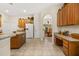 Spacious kitchen with a white refrigerator, wooden cabinets and countertops at 305 Grand Reserve Dr, Davenport, FL 33837