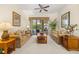 Inviting living room with plush sofas, stylish decor, and seamless access to the screened-in pool area at 305 Grand Reserve Dr, Davenport, FL 33837
