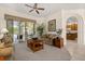 Spacious living room with tile floors, plush sofas, stylish decor, and seamless access to the screened-in lanai at 305 Grand Reserve Dr, Davenport, FL 33837