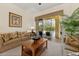Comfortable living room featuring sliding glass doors to the screened-in lanai and pool area at 305 Grand Reserve Dr, Davenport, FL 33837