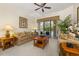 Inviting living room with plush sofas, stylish decor, and seamless access to the screened-in pool area at 305 Grand Reserve Dr, Davenport, FL 33837
