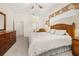 Bright main bedroom features neutral carpeting, ceiling fan, and wood furnishings at 305 Grand Reserve Dr, Davenport, FL 33837