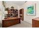 Dedicated home office with carpet, a large desk, and floor-to-ceiling bookshelves for maximum storage at 305 Grand Reserve Dr, Davenport, FL 33837