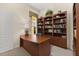 Functional office area with built-in bookcase, large desk and carpet for a comfortable home workspace at 305 Grand Reserve Dr, Davenport, FL 33837
