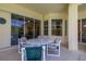 Outdoor patio with a table and chairs with view into the home, perfect for entertaining at 305 Grand Reserve Dr, Davenport, FL 33837