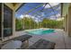 Relaxing poolside with lounge chairs on a screened patio overlooking a private pool and spa at 305 Grand Reserve Dr, Davenport, FL 33837