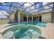 Beautiful screened pool area with integrated jacuzzi and spacious patio at 305 Grand Reserve Dr, Davenport, FL 33837