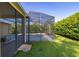 Enclosed outdoor pool and patio providing a private and refreshing oasis with screen enclosure at 305 Grand Reserve Dr, Davenport, FL 33837