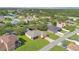 Aerial view showcases a suburban neighborhood with landscaped lawns and modern homes at 3125 Grasmere View Pkwy, Kissimmee, FL 34746
