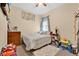 Cozy bedroom with a ceiling fan, window, area rug, and toys scattered on the carpet at 3125 Grasmere View Pkwy, Kissimmee, FL 34746